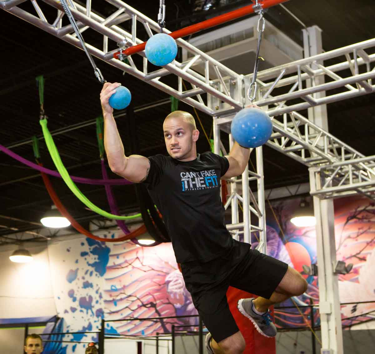 Part of ninja course where the Athletes must grip and swing from cannonball to cannonball and then finally to the distant platform.